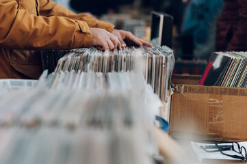 Man hands browsing vinyl album in a record store