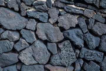 Black stone wall, volcanic stone background