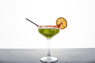 Close up single view of Green margarita with salt and sliced lemon from studio. Includes copy space.