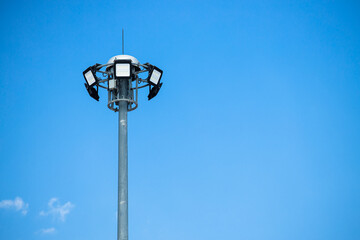 Fototapeta na wymiar High power LED outdoor for street lamp post flood light pole on clear blue sky copy space.
