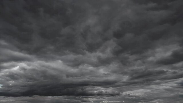 background of dark dramatic sky with stormy clouds timelapse before rain or snow, extreme weather