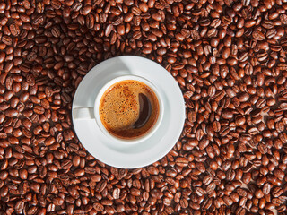 Coffee cup on coffee beans.