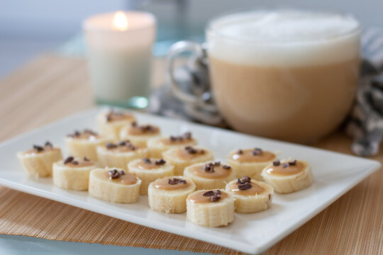 Fast homemade snack: banana canape with cacao nibs, Peanut butter and coffee. Delicious, healthy food