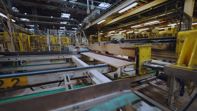 Conveyor for the production of laminate flooring, manufacturer of floor coverings, industrial plant