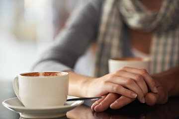 Fototapeta na wymiar Enjoying a coffee shop date. Cropped shot of a couple sitting in a coffee shop.