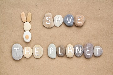 Save the Planet letters and bunny from pebbles on craft paper background. Ecological, eco friendly, zero waste, nature concept. Earth Day flatly top view postcard, banner.