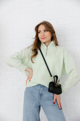 The smallest women's handbag. a fashionable women's accessory. clutch bag with gold hardware. Fine black leather handbag. 