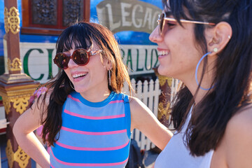 Two friends in vintage style clothes smiling outdoors