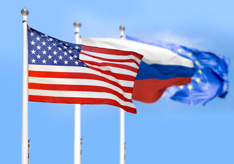 The American ,European Union and Russian flags flying side by side with blue sky