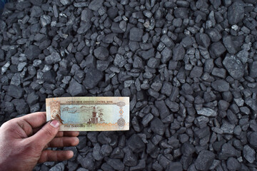  United Arab Emirates dirhams currency showed on coal of mine deposit mineral resources background