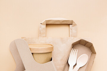 Zero waste, environmentally friendly, disposable, cardboard, paper utensils on a beige background. View from the top. Eco craft paper tableware.