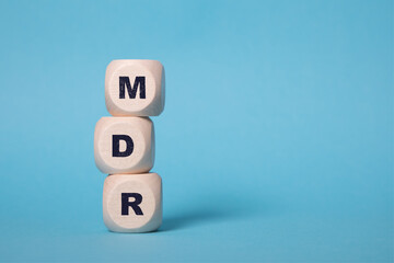 MDR Acronym on wooden blocks isolated on bluebackground, copy space.