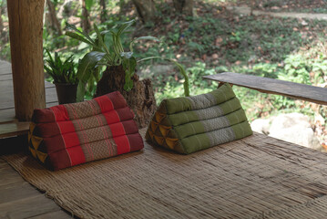 Terrace at the home for relax with Thai triangle pillows on bamboo mat as Northern style Thailand