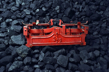 Red weight showed on coal of mine deposit mineral resources background