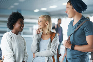How are you finding classes. A group of college students standing together and smiling.