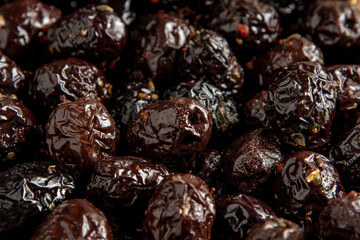 Black olives with paprika and thyme covering the entire screen for background use