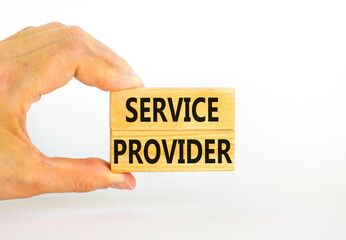 Service provider symbol. Concept words Service provider on wooden blocks on a beautiful white table white background. Businessman hand. Business services and service provider concept, copy space.