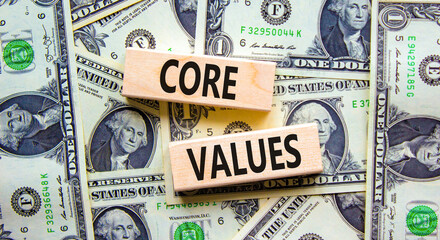 Core values symbol. Concept words Core values on wooden blocks on a beautiful background from dollar bills. Business value and core values concept, copy space.