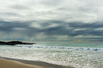 Fototapeta na wymiar Rain clouds over the sea at Currumbin Beach, Queensland, Australia. 