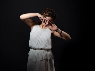 The heroine of an ancient tragedy in grief and loss. A young woman in a white tunic and a laurel...