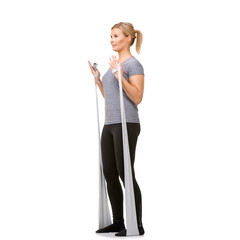 Feel the burn. A young blonde woman exercising with a resistance band - profile.