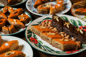 Traditional Turkish holiday Novruz spring holiday green semeni, traditional azerbaijan sweets, shekerbura, qogal, paxlava, mutaki and different nuts and sweets, top view, sweet stuff and Turkish sweet