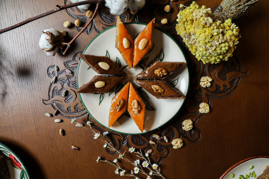 Traditional Turkish holiday Novruz spring holiday green semeni, traditional azerbaijan sweets, shekerbura, qogal, paxlava, mutaki and different nuts and sweets, top view, sweet stuff and Turkish sweet
