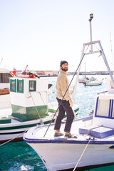 Naklejka premium sailor man on a fishing boat working