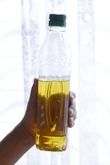 hand holding almond oil with copy space 