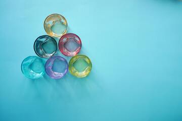 top view of empty drinking glasses on blue background 