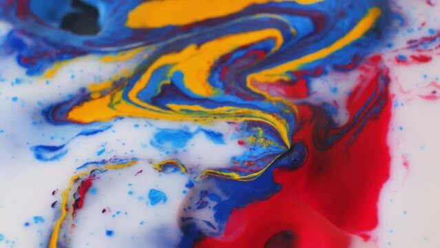 Abstract colorful paint on embossed surface mixes with liquid