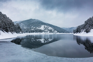 winter season, sunnet lake and snowy landscape
