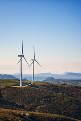 Turbines in a mountain wind farm. Ecological energy production.