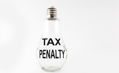 Text TAX PENALTY on the bulb on the white background. Business concept