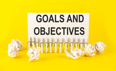white paper on the yellow background with text GOALS AND OBJECTIVES