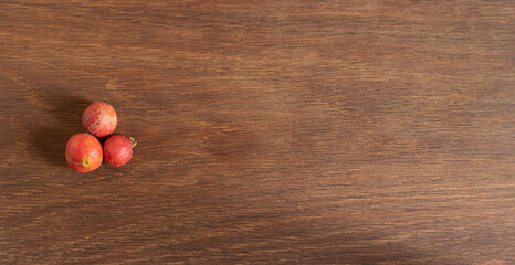 tree red berries on a wooden board with copyspace. wild guava