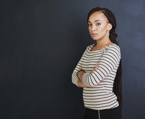 Obraz premium Success is not for the lazy. Studio shot of a young woman standing against a dark background.