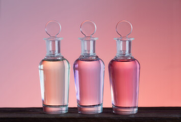 bottles with magic potions on pink background