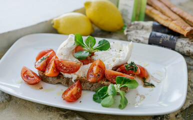 Image of portion of food. Portion with cheese, tomatoes, olive, crabs and vegetables