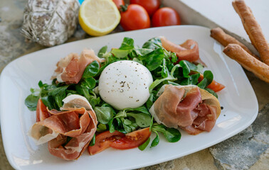 Image of portion of food. Portion with cheese, tomatoes, olive and vegetables