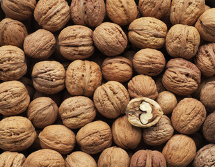 Dried whole and cracked walnuts in a heap, healthy food also an addition to dishes ....  