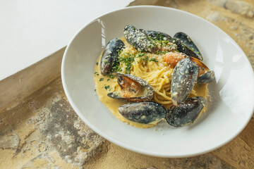 Delicious italian pasta. Portion of pasta with cheese, shrimps and oysters