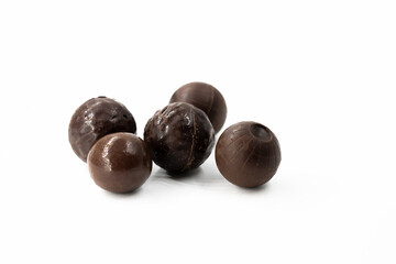 Several round brown chocolate candies with different texture patterns on a white background isolated