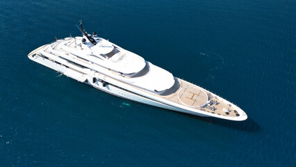 Fototapeta premium Aerial drone ultra wide photo of luxury yacht with wooden deck and helipad anchored near port of Port of Fontvieille in deep blue sea, Monaco, France