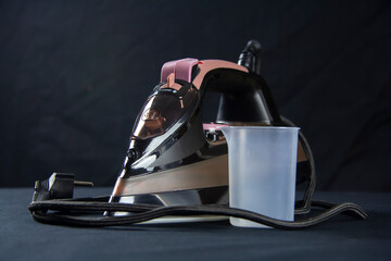 A dark colored iron for ironing laundry. Homework