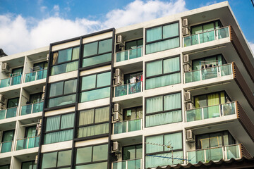 Modern condominium window building against blue sky city resident