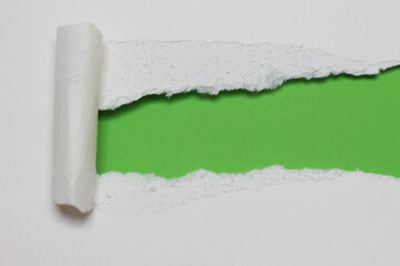 white ripped old paper on green paper background.