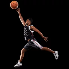 Muurstickers Taking his game up a level. Studio shot of a basketball player against a black background. © Duncan M/peopleimages.com