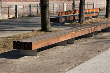 Fototapeta na wymiar Wooden bench on the river bank, Poland, Wroclaw.