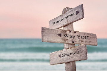 remember why you started text quote written on wooden signpost by the sea. Positive pink turqoise...